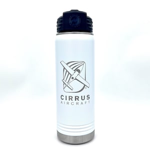May include: White insulated water bottle with a black lid and a silver base. The bottle features the Cirrus Aircraft logo in gray, including an airplane graphic and the brand name. The bottle is designed to keep beverages cold.