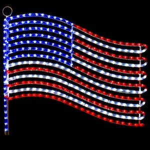 May include: A waving American flag made of red, white, and blue LED lights. The flag has a blue square with white stars in the upper left corner and red and white stripes. The lights are arranged to mimic the flag's design.