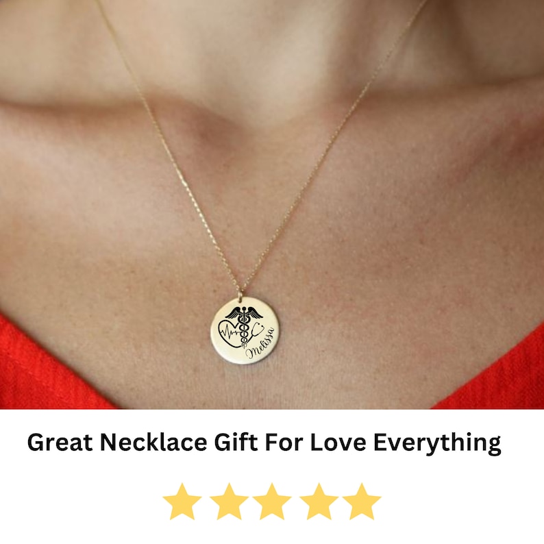 May include: A gold necklace with a round pendant featuring a medical symbol, a heart, and the name "Melissa".