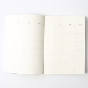 May include: An open blank weekly planner with a grid layout. The days of the week are labeled at the top: Mon, Tue, Wed, Thu, Fri, Sat, Sun.