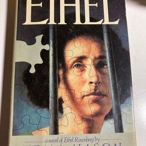 May include: A book titled "Ethel" - The Fictional Autobiography, a novel of Ethel Rosenberg by Tema Nason. The cover features a woman's face behind a jail cell-like pattern.