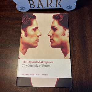 May include: The Oxford Shakespeare, The Comedy of Errors, Oxford World's Classics book cover featuring two men facing each other.