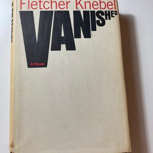 May include: A vintage paperback book titled "Vanished" by Fletcher Knebel. The book cover is off-white with the title in large black letters and the author's name in red. The words "A Novel" are printed at the bottom.