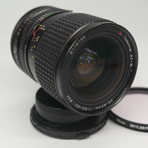 Tokina Zoom-Objektiv AT-X Canon FD 28-85 mm Macro 1:3,5-4,5 Ø 62mm lens With HOYA 62mm Skykight (1B) Japan Filter