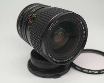 Tokina Zoom-Objektiv AT-X Canon FD 28-85 mm Macro 1:3,5-4,5 Ø 62mm lens With HOYA 62mm Skykight (1B) Japan Filter