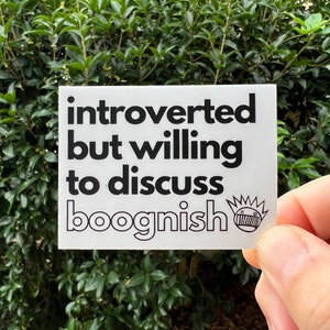 May include: White sticker with black text that reads "introverted but willing to discuss boognish". A small black and white drawing of a face with a crown is in the bottom right corner.