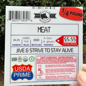 May include: A white sticker with a red label that says "1/4 POUND". The sticker has a barcode, a logo for an organic butcher shop, and text that says "MEAT". The sticker also has a price tag that says "$5.55 TOTAL PRICE". The sticker also has a USDA Prime logo and a safe handling instructions label.