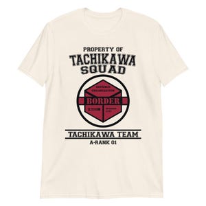 May include: Cream-colored t-shirt with the text "PROPERTY OF TACHIKAWA SQUAD" in black. Below is a circular emblem with the word "BORDER" and Japanese text. The shirt also says "TACHIKAWA TEAM A-RANK 01".