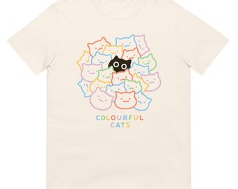 May include: Cream-colored t-shirt featuring a colorful graphic of cartoon cat faces in various colors, with one black cat in the center. The text "COLOURFUL CATS" is printed below the cats in rainbow colors.