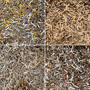 May include: A close-up of shredded paper in four different colors: brown, yellow, white, and blue. The paper is arranged in a grid pattern.