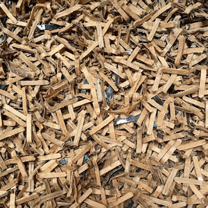 May include: A close-up of brown shredded paper, commonly used as packing material for shipping fragile items.