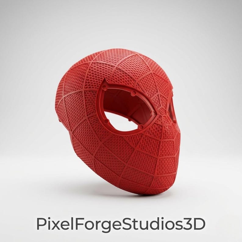K&ouml;nnte beinhalten: Eine rote Spider-Man-Maske mit strukturierter Oberfl&auml;che und Augen&ouml;ffnungen. Die Maske hat eine einfarbige Farbe und weist ein netzartiges Muster auf. Der Text "PixelForgeStudios3D" befindet sich unten.