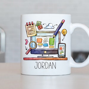 May include: White ceramic mug featuring a colourful illustration of a computer, a magnifying glass, a notepad, a pencil, and a lightbulb. The text "JORDAN" is printed on the mug.