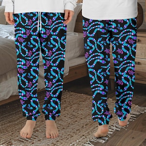 May include: Black sweatpants with a blue and purple snake pattern. The snakes are outlined in white.