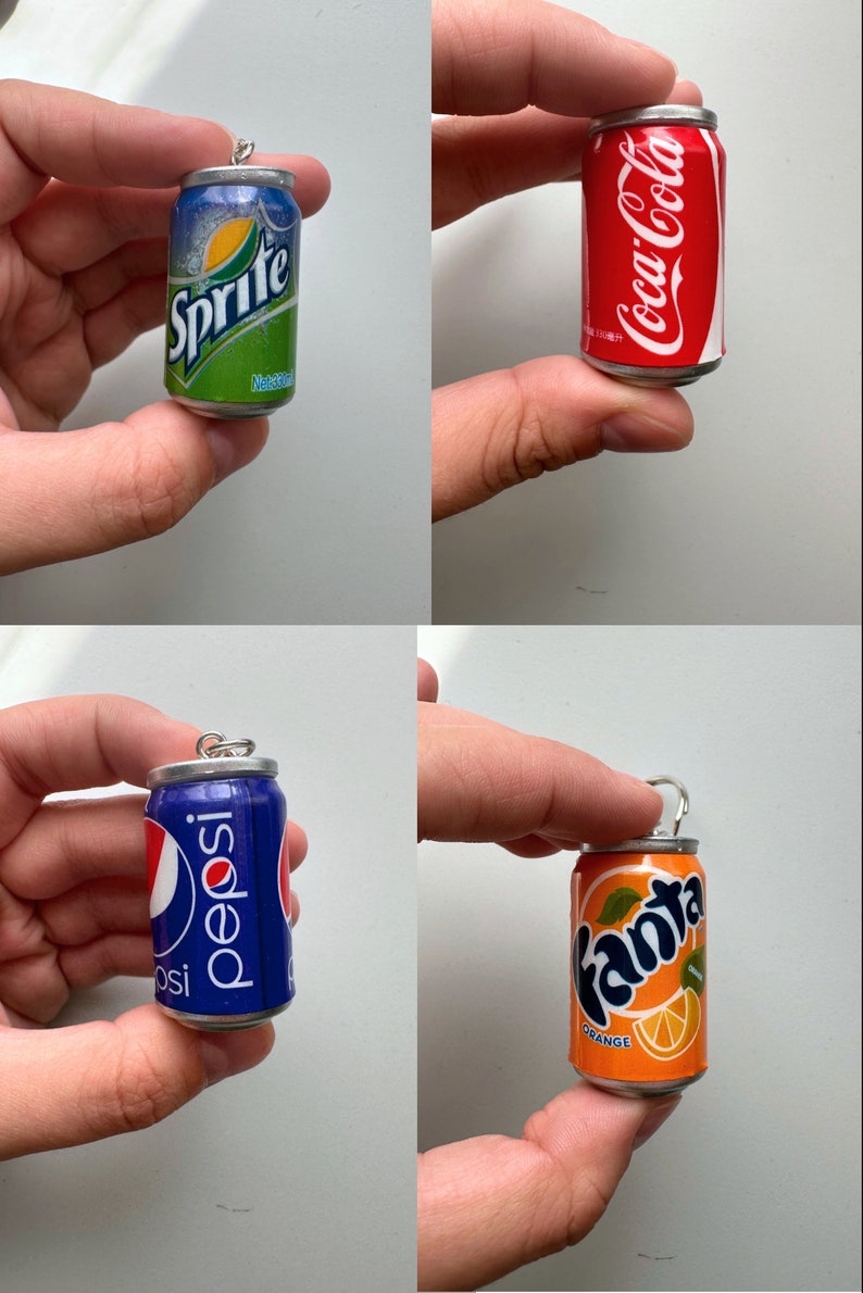 May include: Four miniature soda can charms, each featuring a different brand: Sprite, Coca-Cola, Pepsi, and Fanta Orange. The charms are silver with a pull tab and are made to look like real soda cans.