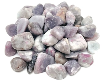 May include: A pile of tumbled lepidolite stones. The stones are a mix of light purple, white, and pink.