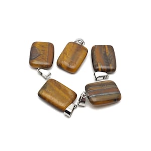 May include: Five brown tiger's eye stone pendants with silver jump rings. The stones are rectangular and have a natural, striated pattern.
