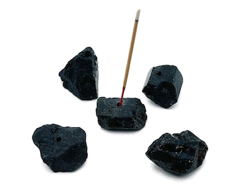 May include: Black tourmaline incense holder with five pieces of black tourmaline and an incense stick burning.