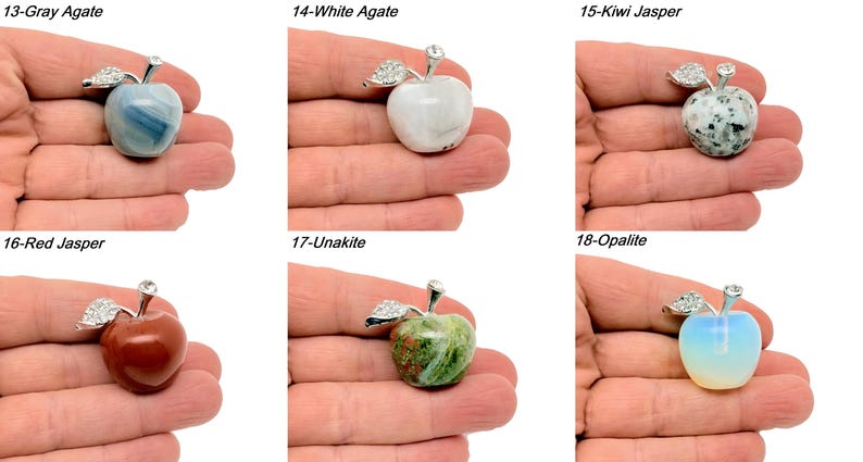 May include: Six different gemstone apple pendants, each with a silver setting and a crystal on top. The stones are gray agate, white agate, kiwi jasper, red jasper, unakite, and opalite.