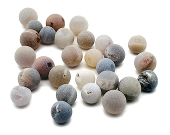 May include: A collection of 20 agate beads in various shades of brown, gray, and white. The beads are smooth and polished, with a natural, organic look.