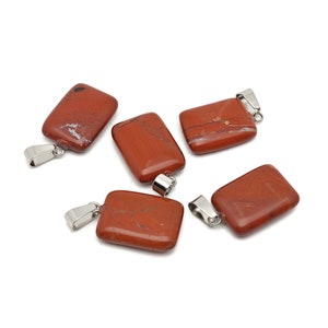 May include: Five red jasper stone pendants with silver jump rings. The stones are rectangular and have a natural, marbled appearance.