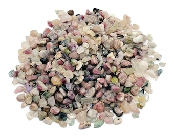 May include: A pile of small, colorful tumbled stones. The stones are a mix of pink, green, purple, and clear. They are all about the size of a pea.