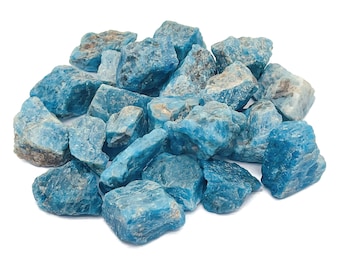 May include: A pile of blue apatite rough stones. The stones are various sizes and shapes, with some having a more crystalline appearance.