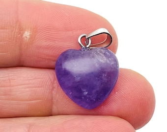 May include: A purple amethyst heart pendant with a silver bail.