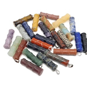 May include: A collection of 20 colourful gemstone pendants shaped like bamboo tubes. The pendants are made of various stones, including amethyst, lapis lazuli, tiger's eye, and jasper.