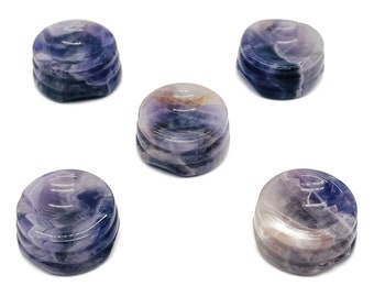 May include: Five amethyst crystal coasters in various shades of purple and white. The coasters are round and have a slightly domed shape.