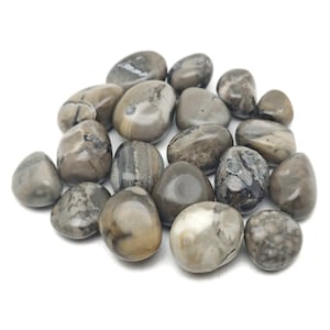 May include: A collection of tumbled moss agate stones. The stones are a mix of brown, gray, and white with swirling patterns.
