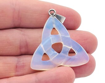 May include: A white opal Celtic knot pendant with a silver bail. The pendant is in the shape of a trinity knot, a traditional Celtic symbol of love, faith, and hope.