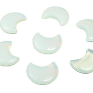 May include: Seven white crescent moon shaped polished stones. The stones are translucent and have a slight iridescent sheen.