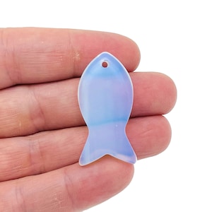 May include: A light blue opal fish charm with a hole at the top for hanging.