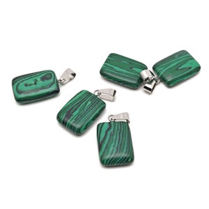 May include: Five green malachite stone pendants with silver jump rings. The stones are rectangular and have a swirling pattern.
