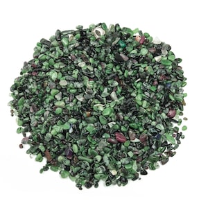 May include: A pile of small, green, black and red gemstones. The gemstones are tumbled and have a smooth, polished finish.