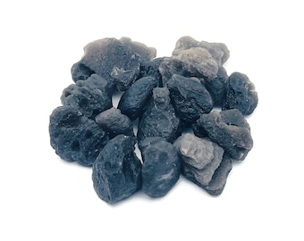 May include: A pile of dark gray and black volcanic rock stones. The stones are rough and have a natural, irregular shape.