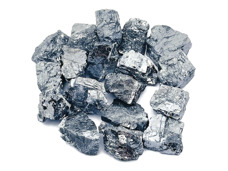 May include: A pile of rough, gray, metallic-looking stones. The stones are irregularly shaped and have a slightly shiny surface.