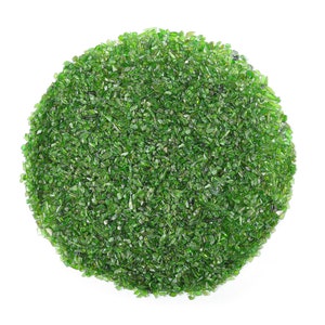 May include: A close-up of a circle of green peridot gemstones. The peridot crystals are small and have a shiny, translucent appearance.
