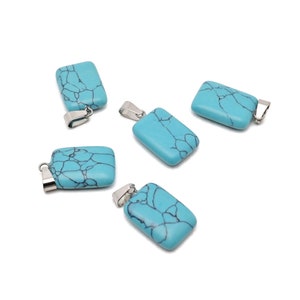 May include: Five turquoise blue pendant charms with silver bail loops. Each charm is rectangular and features a marbled pattern.