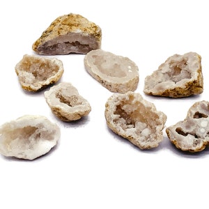 May include: A collection of geode specimens, each with a rough, tan exterior and a crystalline interior. The geodes vary in size and shape, showcasing a range of natural formations. The crystals inside are a light, translucent color.