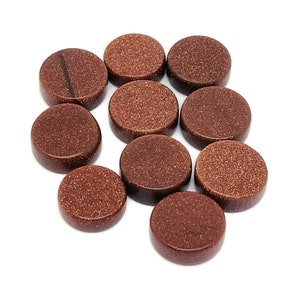 May include: Ten round, flat, brown sandstone cabochons. The cabochons have a rough, textured surface.