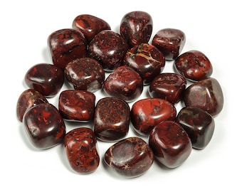 May include: A collection of tumbled red jasper stones. The stones are smooth and polished, with a variety of red and brown hues.