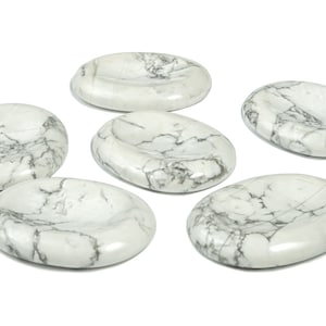May include: Six oval, polished white stones with grey veining. The stones are smooth and have a slightly concave surface, creating a natural dish-like appearance. The stones are arranged on a white background.