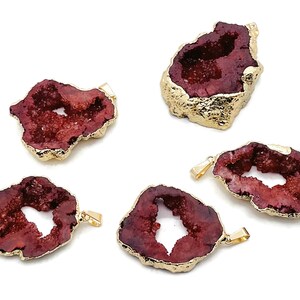May include: Five red agate pendant charms with gold-plated edges. Each charm has a unique shape and a natural crystal formation.