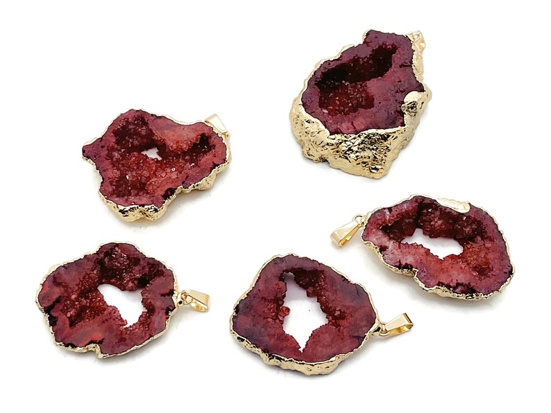 May include: Five red agate pendant charms with gold-plated edges. Each charm has a unique shape and a natural crystal formation.