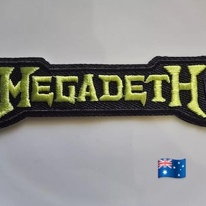 May include: A black embroidered patch featuring the word "MEGADETH" in neon green, distinctive lettering. The patch has a unique shape with pointed ends. An Australian flag is in the lower right corner.