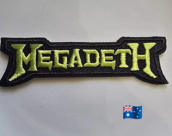 May include: A black embroidered patch with the word "MEGADETH" in neon green, stylized lettering. The patch has a unique shape with pointed ends. An Australian flag is in the lower right corner.