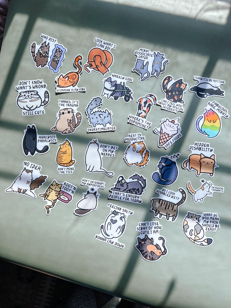 May include: A set of 24 cat-themed stickers with various humorous and relatable phrases. The stickers feature cartoon cats in different poses and expressions, with text such as "Don't know what's wrong, still cute", "Analysis paralysis", "Where's the dopamine?", "Rest is productive", "Hidden disability", "Feeling salty", "That's enough people for today", "Can't lose sight of how cute I am", and "What do you mean my pain should be zero?"