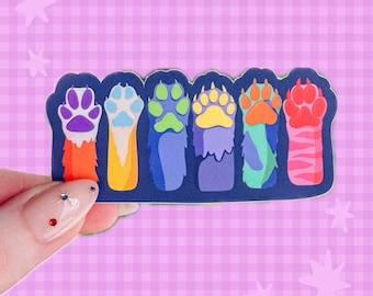 May include: A rectangular sticker featuring six distinct animal paws arranged in a row. Each paw displays a unique color palette, including purple, blue, green, yellow, orange, and pink, set against a dark blue background with a white border.